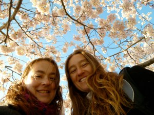 The author and her sister under a blooming cherry tree